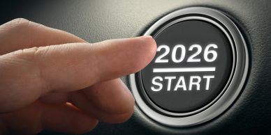 Finger about to press a 2026 start button.