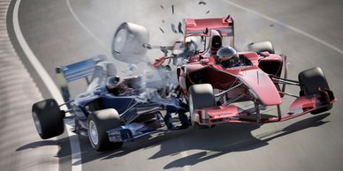 Two Formula 1 cars collide on the track, causing debris to fly.